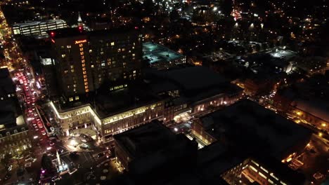 Aerial-turn-around-Lancaster-Pennsylvania-nighttime-downtown-traffic