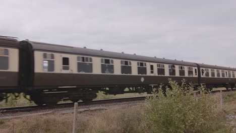 Antique-passenger-train-passing-through-a-heritage-railway-in-Blue-Anchor,-England