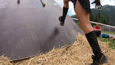Obstacle-racing-athlete-running-up-slip-wall-obstacle-at-an-obstacle-race