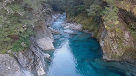 Beautiful-view-from-a-suspension-bridge-on-crystal-clear-water-in-a-river-in-New-Zealands
