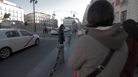 Asian-Tourists-in-a-guided-tour,-visiting-Puerta-del-Sol-Kilómetro-Cero-in-Madrid,-starting-point-of-roads-is-Spain