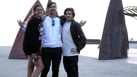 Three-youths-posing-infant-of-the-North-sails-sculpture-Geelong,-Eastern-Beach