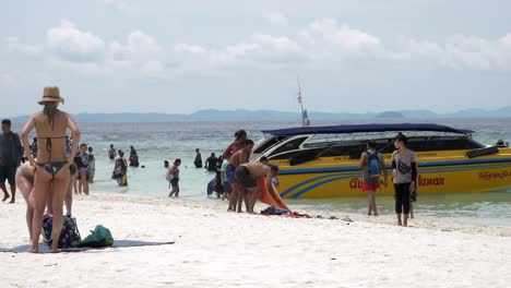 Travelers-travel-to-the-island-by-boat-to-see-the-beauty-and-sunbathing-at-the-beach-front,-with-a-long-beach,-suitable-for-swimming-at-Krabi-in-Thailand