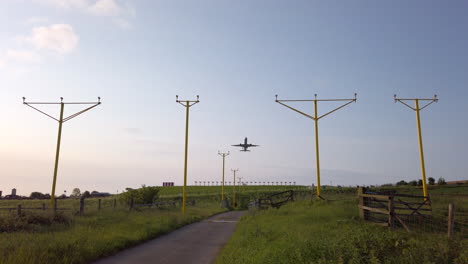 Static-Shot-of-Airplane-Departing-from-Leeds-Bradford-International-Airport-in-Yorkshire-on-Beautiful-Summer’s-Morning-with-Approach-Lighting-System-in-Foreground