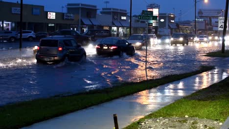 cars-splashing-water-in-heavy-rain-and-flooded-road