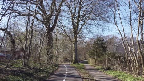 Cycling-down-an-empty-cycle-road-in-a-forrest