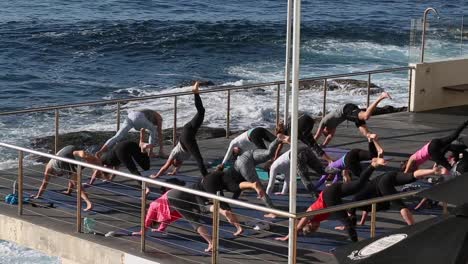 A-early-morning-outdoor-group-yoga-class-at-Bondi-Beach-next-to-the-ocean