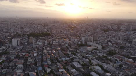 Aerial-shot-of-Tokyo-city-during-sunset,-concrete-jungle-all-over-the-horizon