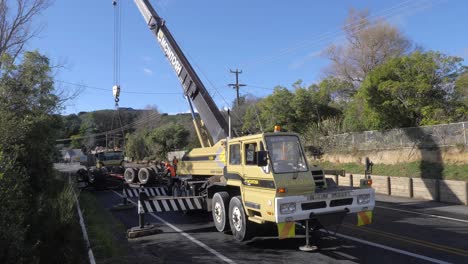 An-upturned-logging-trailer-is-lifted-to-make-upright-and-clear-the-road-after-a-rollover-event