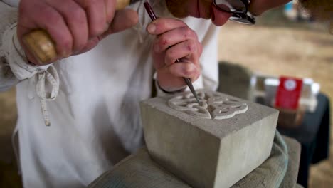 A-stonemason-demonstrates-the-carving-of-sandstone-at-the-festival