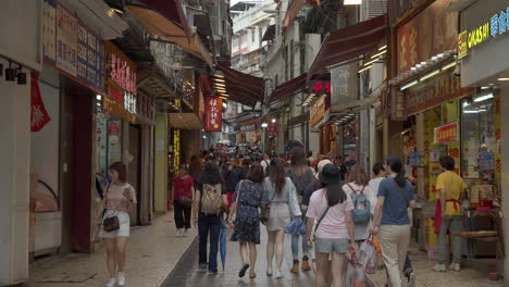 Time-lapse-of-busy-Macau-shops-street-with-numerous-crowds-of-tourists-passing-back-and-forth,-Macau-SAR,-China