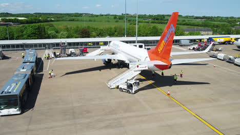 Tracking-shot-of-a-Sunwing-airplane-taxiing-to-its-arrival-terminal-gate