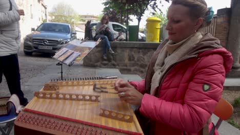 Woman-playing-a-Typical-instrument-in-the-streets-of-Toledo,-Spain