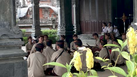 Group-of-Asian-men-in-religious-wardrobe-making-music-in-a-Hindu-temple-in-Bali,-Indonesia