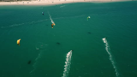 high-altitude-top-down-drone-shot-of-Kite-surfers-in-turquoise-Atlantic-ocean