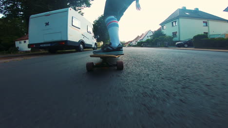 male-person-with-white-high-socks-longboarding