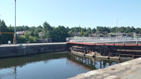 Cyclist-bike-riding-across-British-canal-waterway-gate-railings-sightseeing