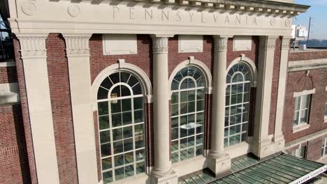 Descending-aerial-of-historic-Lancaster-Train-Station,-home-of-Amtrak-light-rail,-train-travel-theme-in-USA