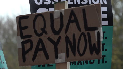 UK-November-2019:-Striking-lecturers-on-a-picket-line-hold-placards-with-slogans-calling-for-equal-pay-and-in-defence-of-pensions