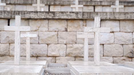 Rows-of-white-small-simple-stone-crosses-at-Polish-cemetery-at-Monte-Cassino,-Italy,-close-up-static