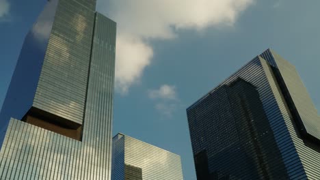 Time-lapse-of-clouds-movement-over-Samsung-Electronics-office-buildings-in-Gangnam,-Seocho-district,-slow-tilt-up-motion-revealing-design