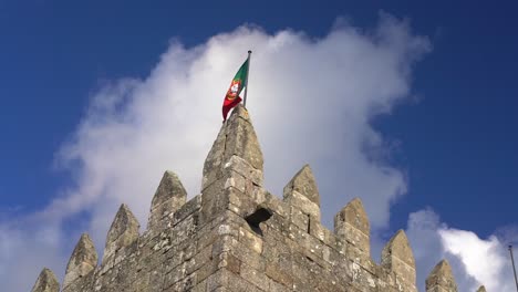 Zoom-Out-From-Portugal-Flag-On-Top-Of-Castle-In-Guimaraes,-Portugal