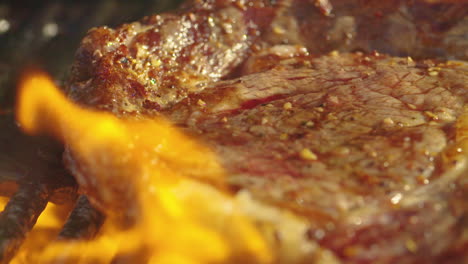 Close-up-of-a-juicy,-delicious-steak-cooking-on-a-grill