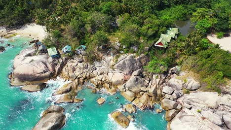 Ao-than-sadet-bay-rocky-shore,-turquoise-sea-water-and-exotic-trees