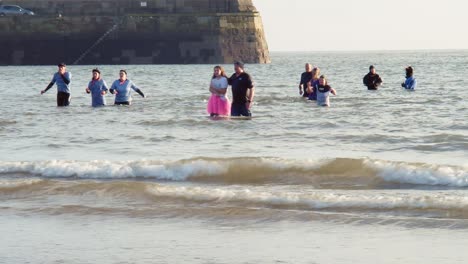 Gente-Disfrazada-Que-Regresa-De-Un-Baño-Frío-Para-Nadar-En-El-Mar-El-Día-De-Año-Nuevo-Anual-De-Scarborough