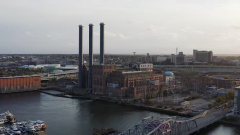 Aerial-view-of-a-power-station,-city-and-highway-traffic-in-Providence,-Rhode-Island---aerial-view