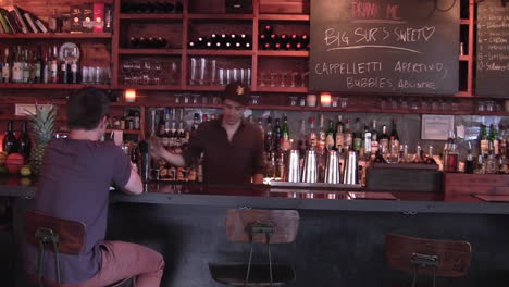 Bartender-Takes-an-Order-From-Young-Hipster-Dude-Sitting-Alone-at-the-Bar