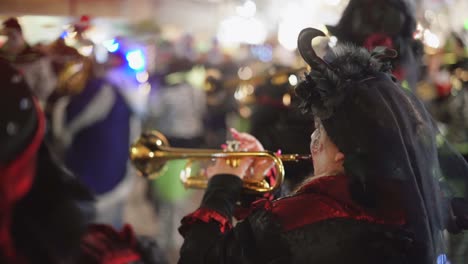 Static-close-up-of-female-musician-playing-trumpet-instrument-on-outdoor-party