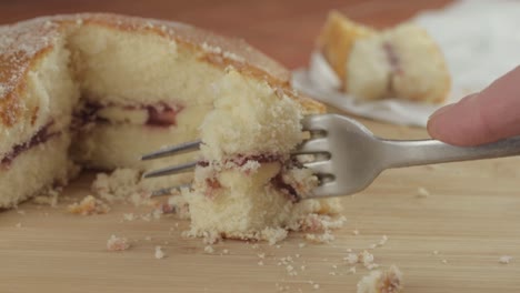 Eating-slice-of-Victoria-sponge-cake-with-fork-close-up-shot