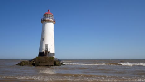 Tourist-child-playing-and-splashing-in-ocean-water-at-Landmark-Ayr-lighthouse