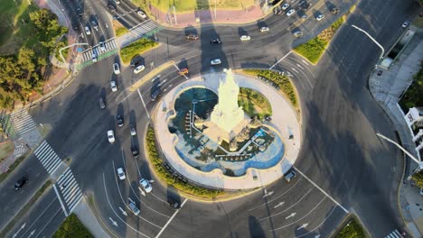 High-angle-aerial-orbiting-around-a-roundabout-and-the-Monument-of-the-Spanish-at-golden-hour