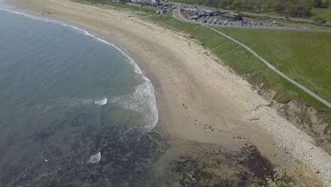 Aerial-birds-eye-view-drone-view-of-Seaburn-Beach,-Sunderland,-North-East-England,-UK-on-a-summer-days