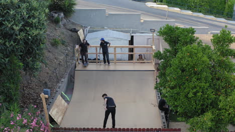 Backyard-skateboarders-practicing-on-homemade-mini-ramp