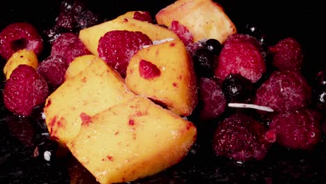 Thawing-process-of-frozen-mangos,raspberries,black-currant-and-coconut-chips