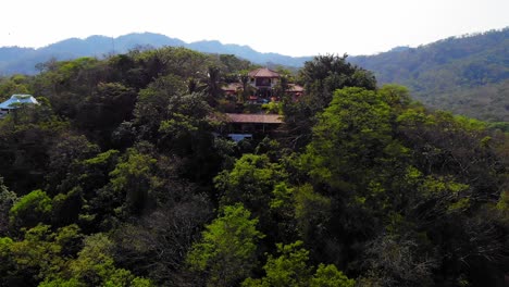 Lowering-drone-shot-of-a-resort-in-Tamarindo-Costa-Rica,-Los-Altos-de-Eros