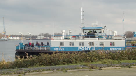 Amsterdam-ferry-leaving-dock-and-crossing-river-in-the-Netherlands---wide