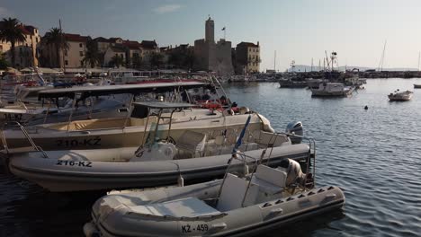 Slow-pan-of-the-many-boats-docked-along-the-shore-of-Komiza-on-the-island-of-Vis-in-Croatia