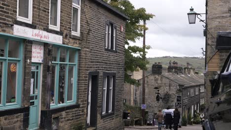 Shoppers-browsing-in-cobbled-street-in-Yorkshire-village-Haworth