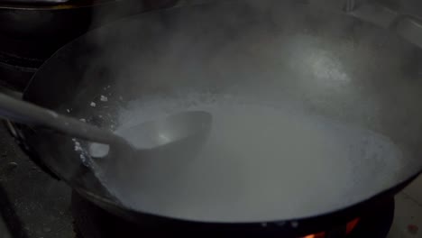 Commercial-kitchen,-giant-wok-cooking-in-slow-motion