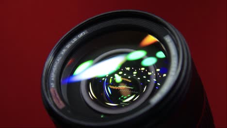 Close-Up-of-DSLR-Camera-Lens-In-Red-Background