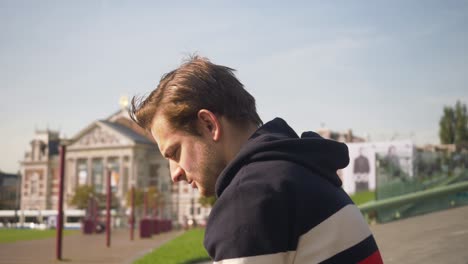 Handsome-young-man-taking-pictures-of-the-Stedelijk-museum-in-Amsterdam-with-the-cellphone-at-daylight