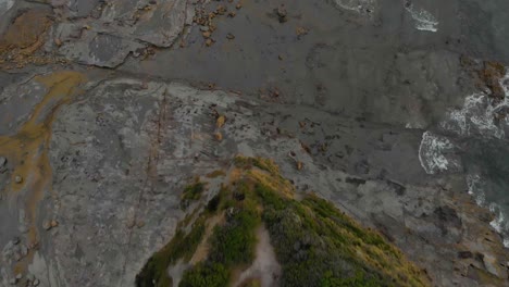 A-birds-eye-view-aerial-shot-of-people-at-a-look-out-at-eagles-nest-on-Bass-coast-Victoria