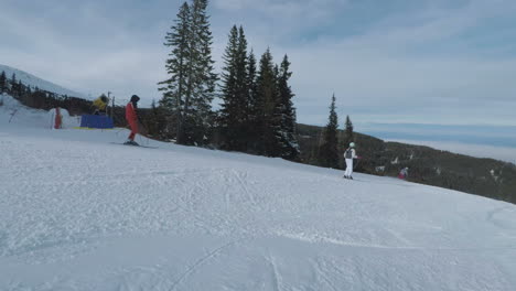 A-couple-of-people-quickly-descending-a-hill-on-snowboards