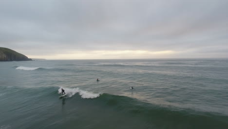 Cinematic-flying-of-surfers-surfing-along-coast-of-East-London-South-Africa-aerial