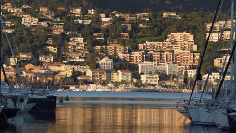 Bormes-les-Mimosas-harbour-and-"Le-Lavandou"-town-in-the-background,-Mediterranean-sea---South-of-France