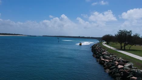 A-powerful-jet-boat-full-of-excited-tourist-speed-past-close-to-a-breakwall